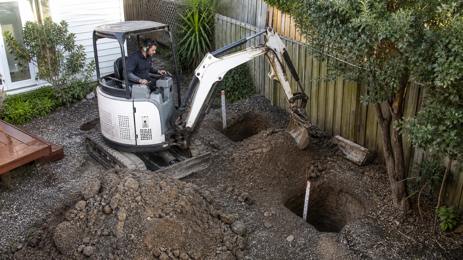 Small excavator completing careful residential digging work
